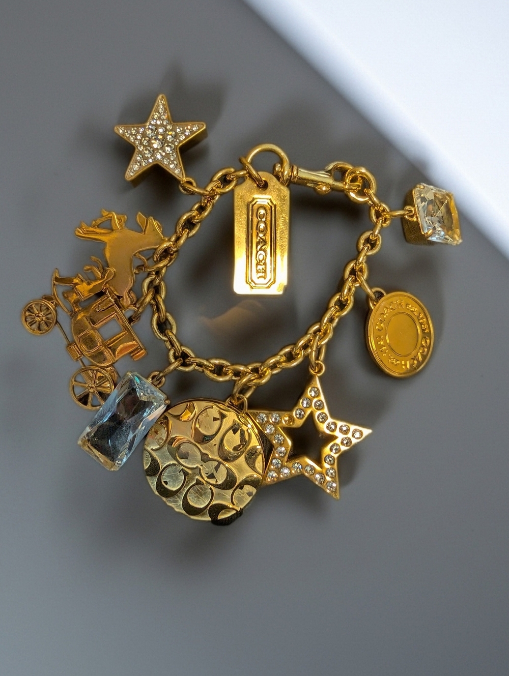 Coach Gold-Tone Charm Bracelet with Clear Crystal Accents and Photo Locket